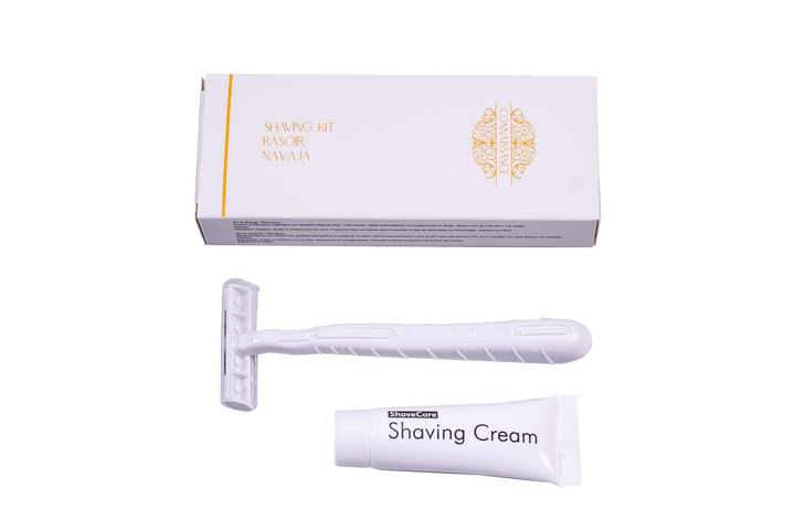 Shaving kit with razor, cream, and packaging on a white background