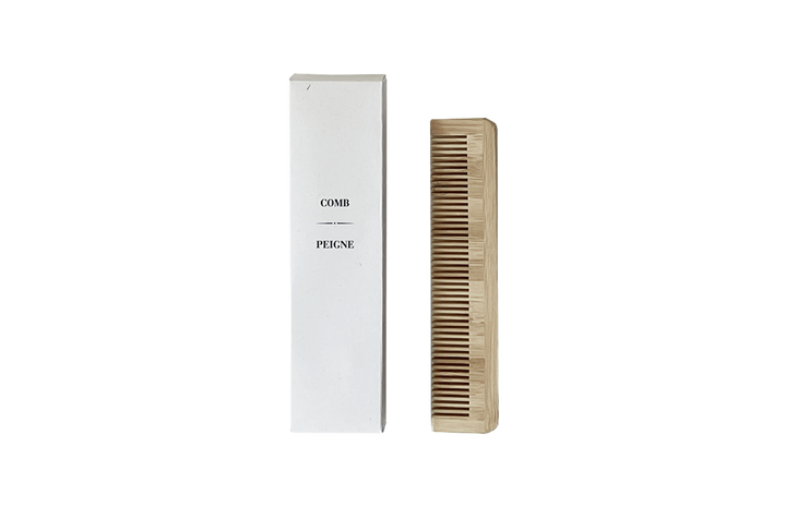 Wooden comb and white packaging with 'Pigeon' branding on a white background